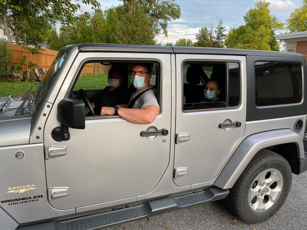 photo of a family in a jeep